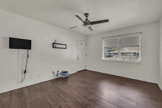 a view of a room with wooden floor and windows