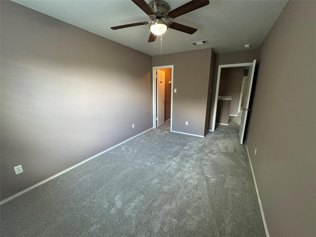 3200 Crownover Street Austin, TX 78725 - Photo 8 of 23 A spacious and inviting room with soft gray carpeting offers endless possibilities for personalization.