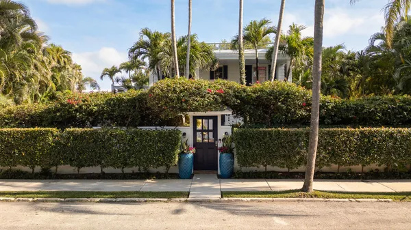 a house that has a tree in front of it