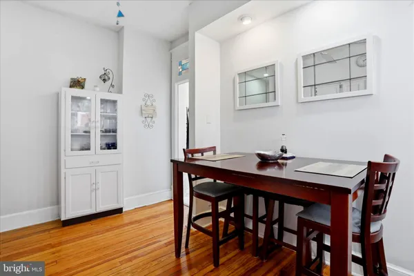 a view of a dining room with furniture and wooden floor
