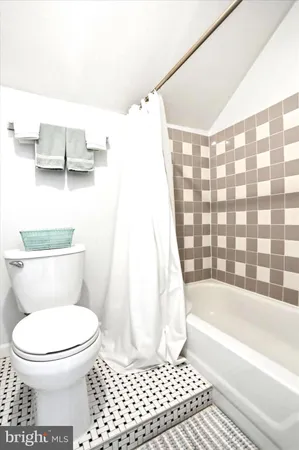 a bathroom with a toilet and a bathtub