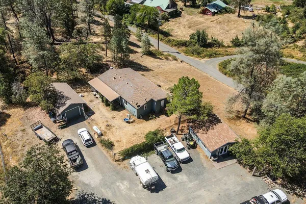 an aerial view of a house with yard and parking