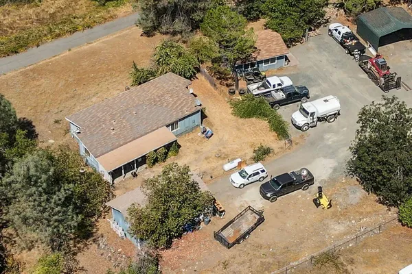 an aerial view of a house with yard swimming pool and outdoor seating