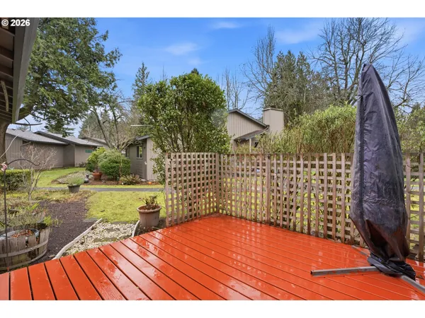 a view of a backyard with wooden fence