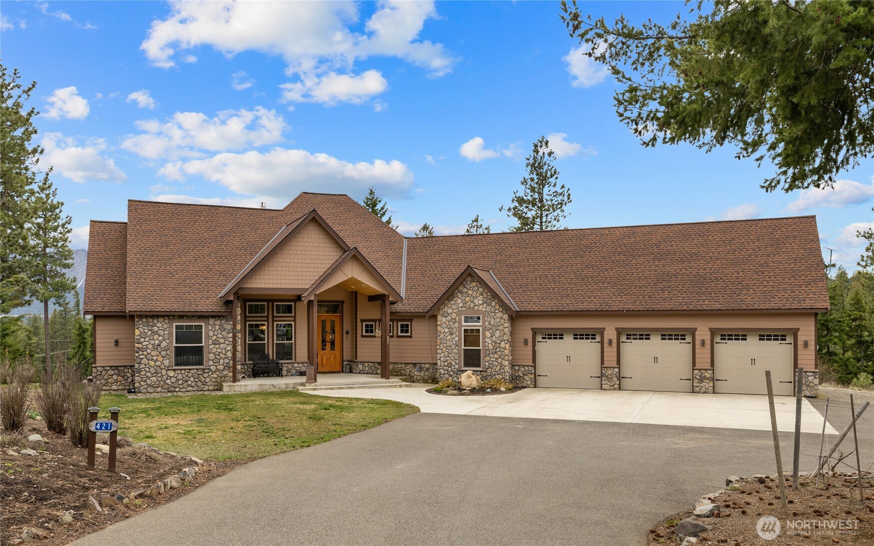 421 Meadow Ridge Drive Cle Elum, WA 98922 - Photo 1 of 39 a front view of a house with a garden