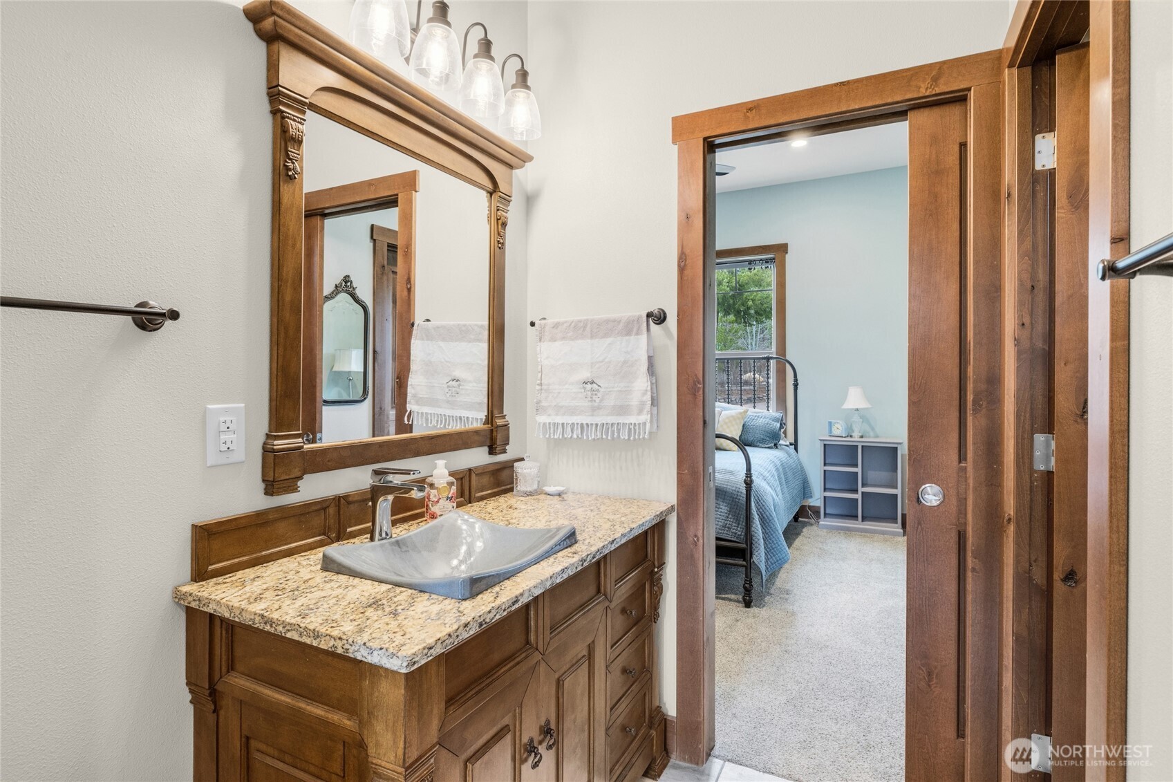 421 Meadow Ridge Drive Cle Elum, WA 98922 - Photo 19 of 39 a bathroom with a granite countertop sink a mirror and a bathtub