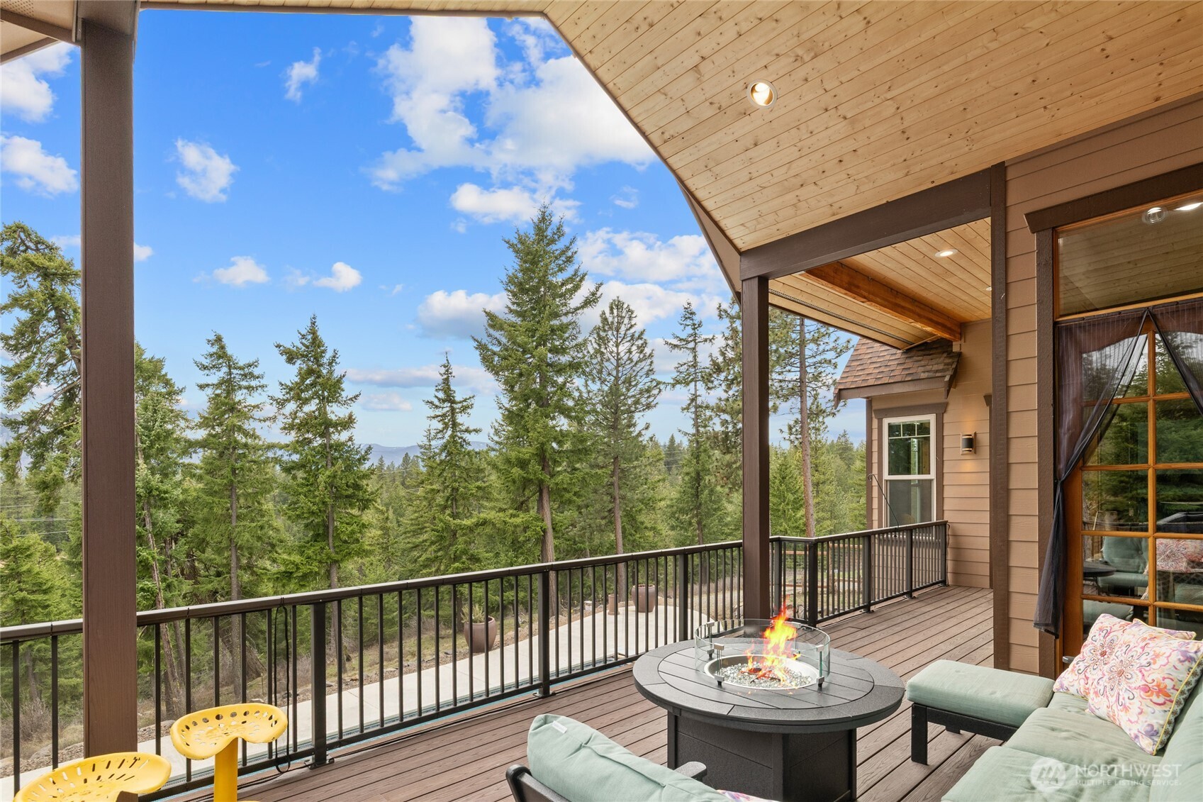 421 Meadow Ridge Drive Cle Elum, WA 98922 - Photo 31 of 39 a view of a balcony with a dining table and chairs with wooden floor