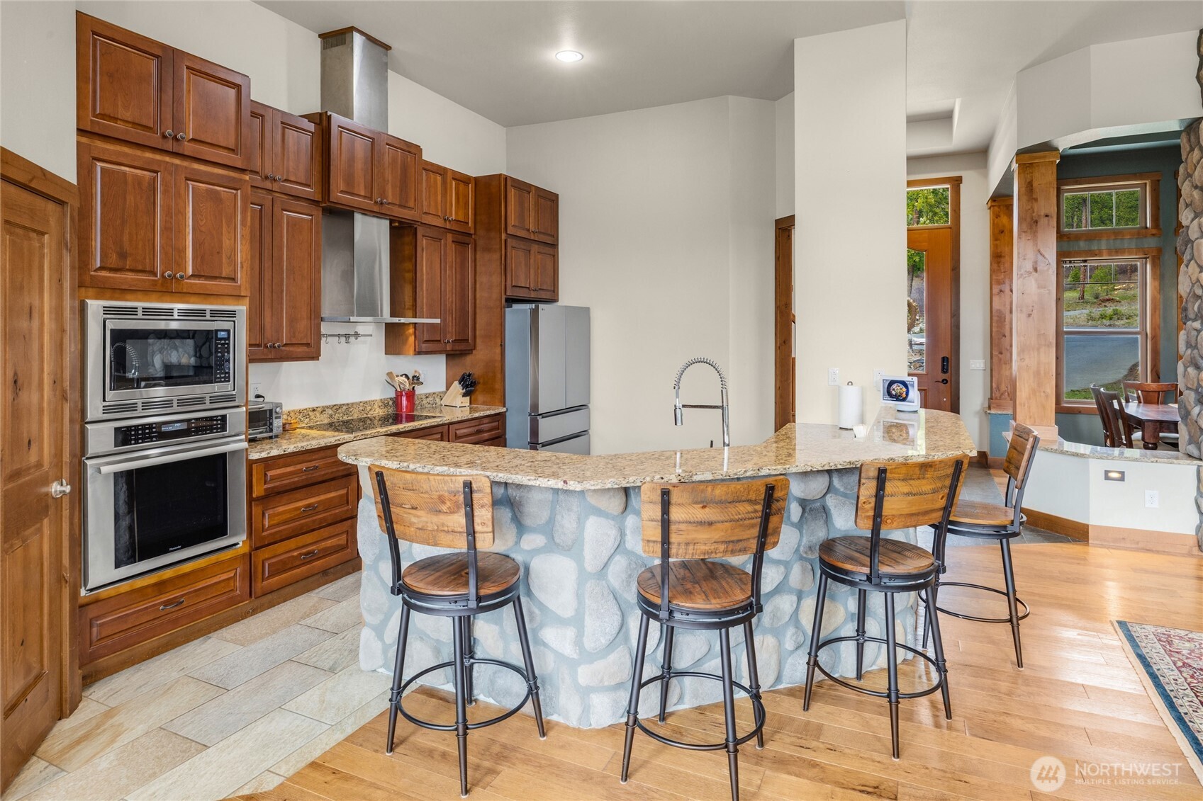 421 Meadow Ridge Drive Cle Elum, WA 98922 - Photo 10 of 39 a kitchen with a table chairs stove and cabinets