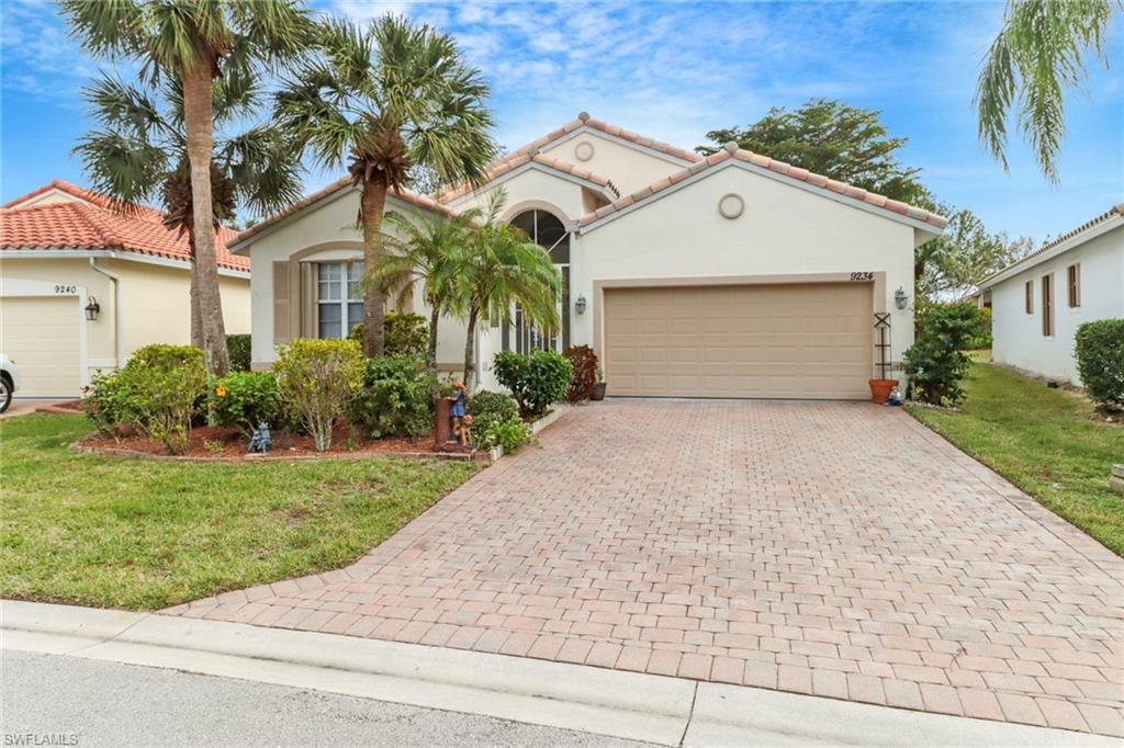 9234 Springview Loop Estero, FL 33928 - Photo 1 of 43 a front view of a house with a yard and garage