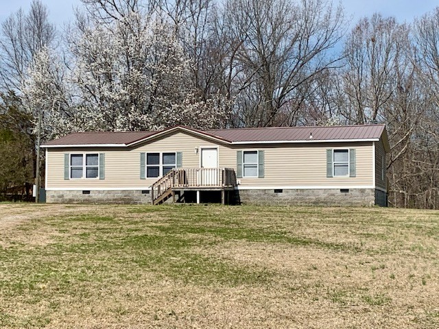 a house that has a tree in front of the house