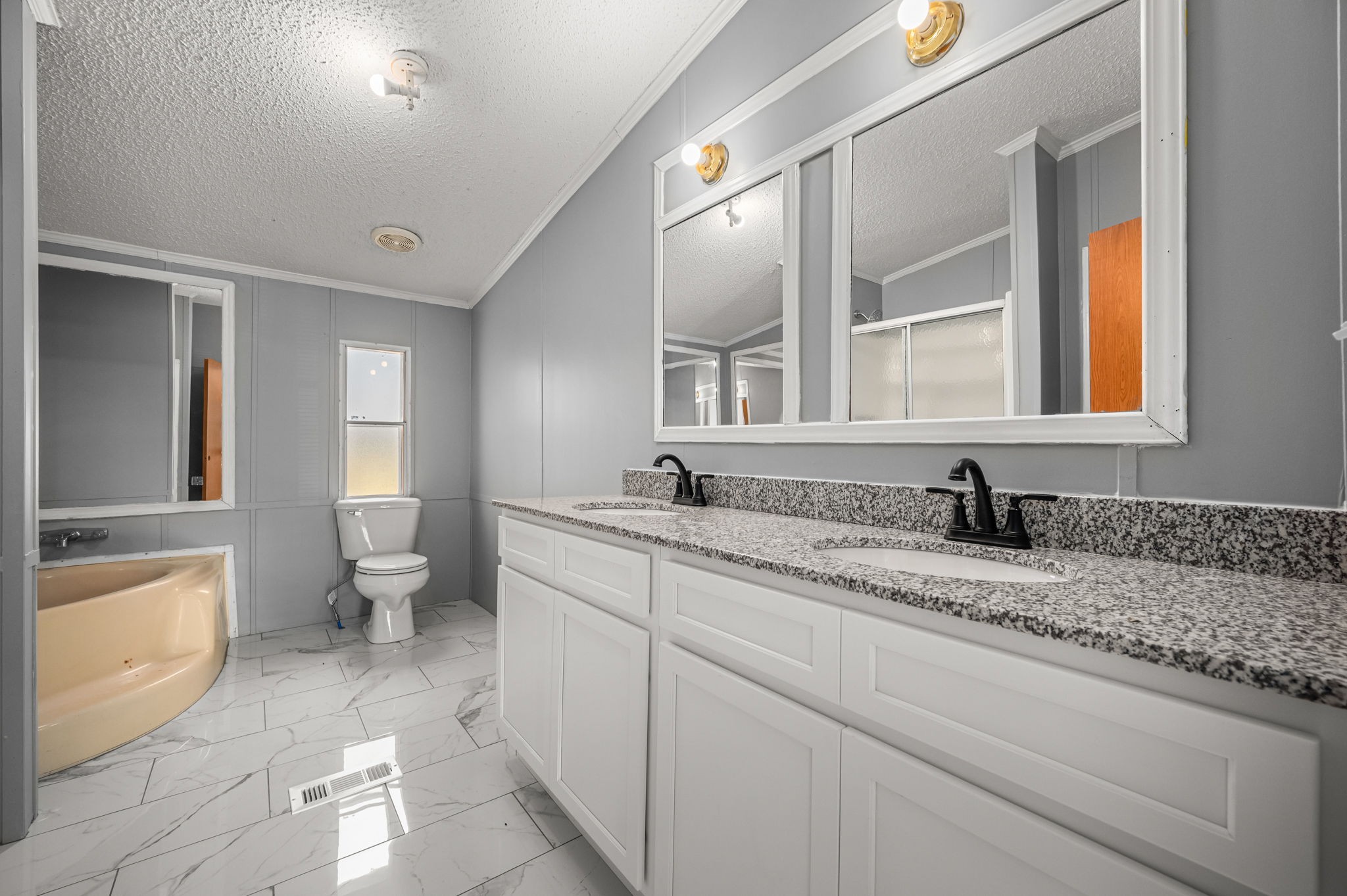 1174 Throneberry Road Normandy, TN 37360 - Photo 17 of 29 a spacious bathroom with a granite countertop sink a toilet and a mirror