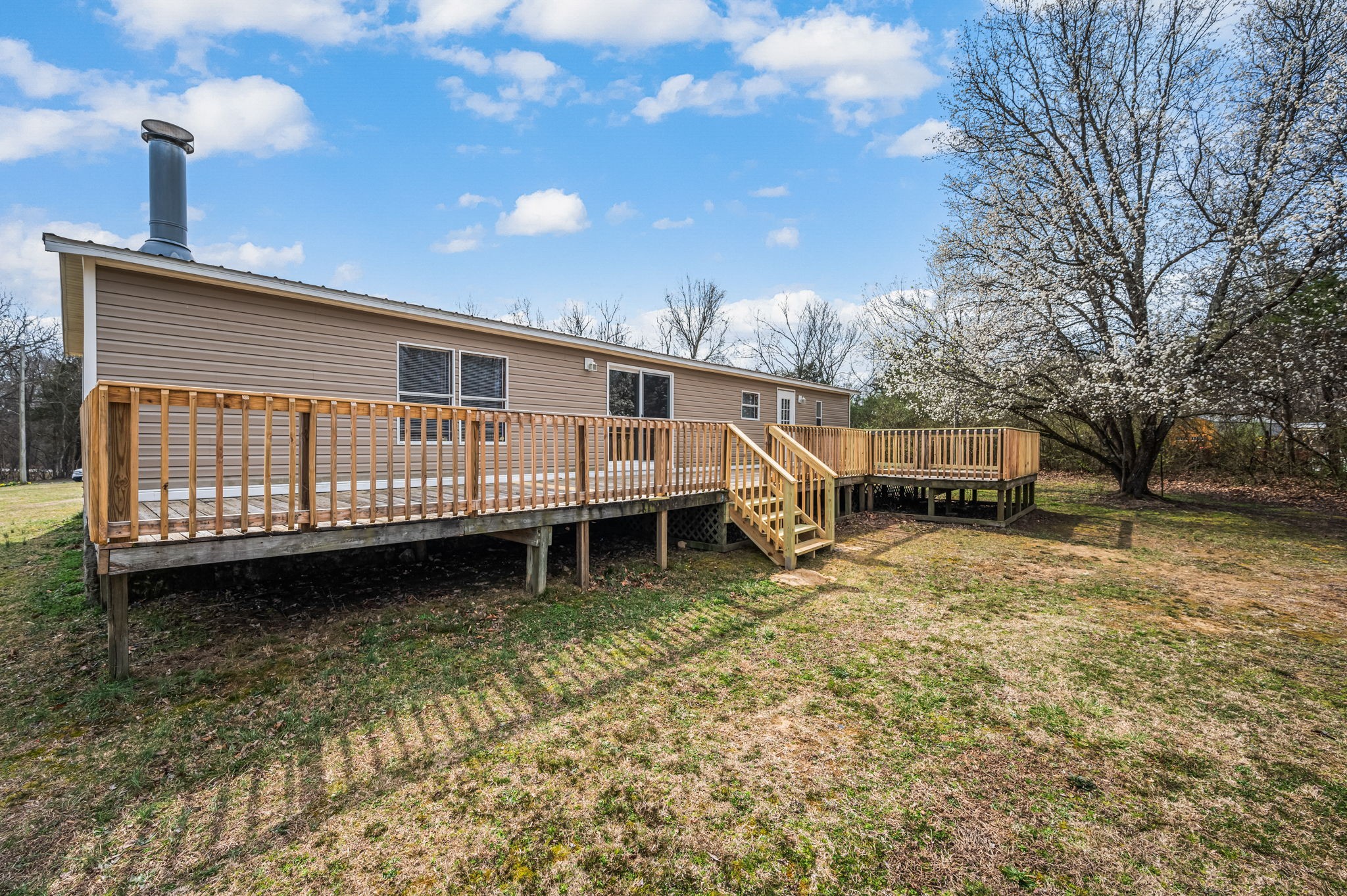 1174 Throneberry Road Normandy, TN 37360 - Photo 26 of 29 a front view of a house with a yard and garage