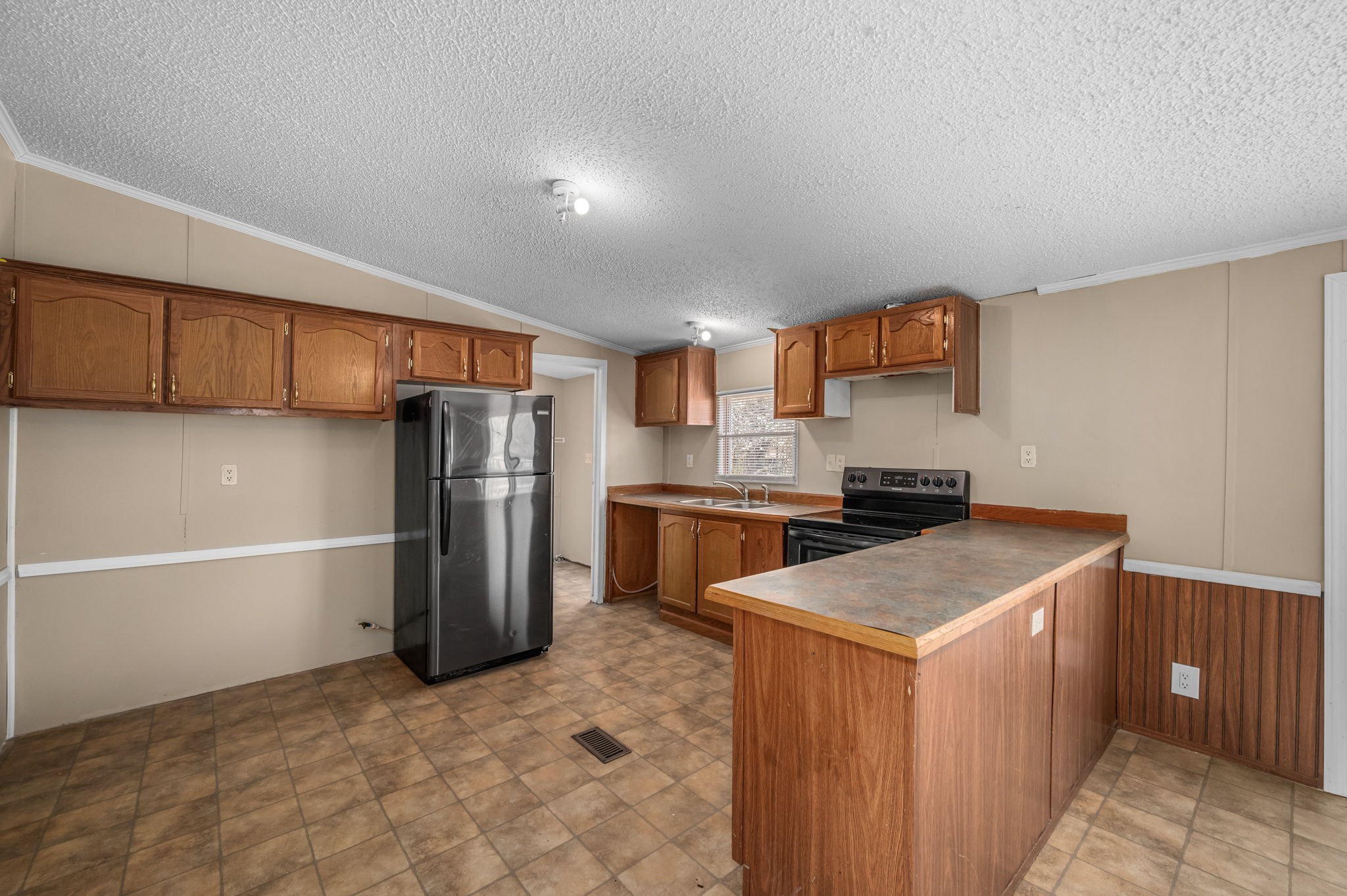 1174 Throneberry Road Normandy, TN 37360 - Photo 7 of 29 a kitchen with stainless steel appliances a refrigerator and a stove top oven