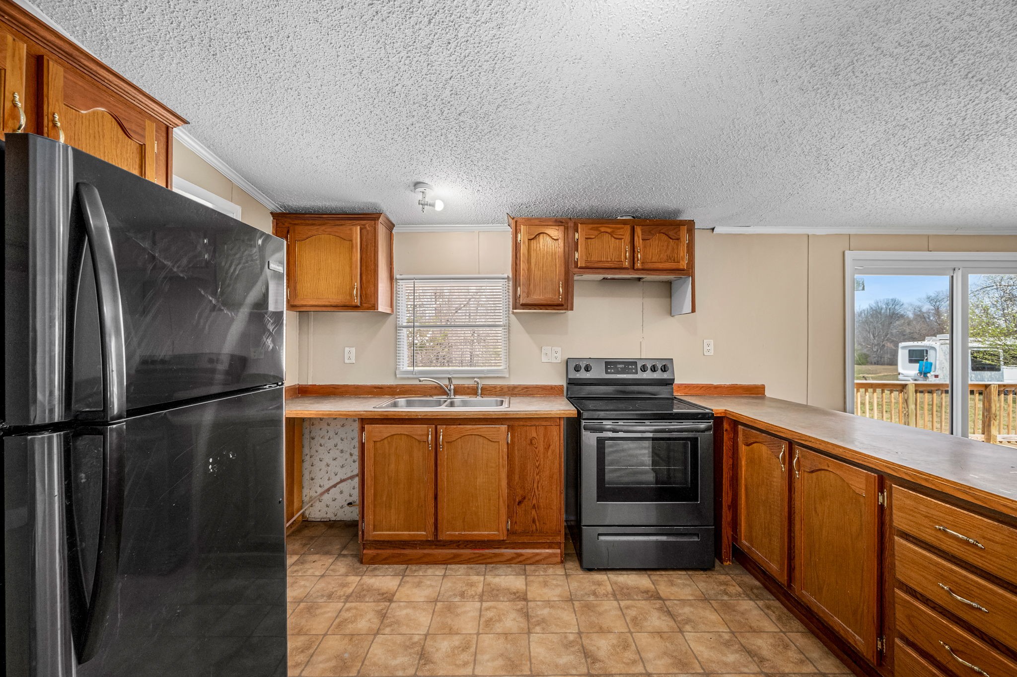 1174 Throneberry Road Normandy, TN 37360 - Photo 8 of 29 a kitchen with stainless steel appliances granite countertop a stove a refrigerator and a sink