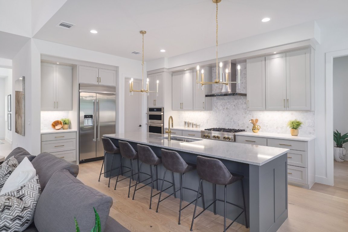1703 Piedmont Avenue Austin, TX 78757 - Photo 11 of 37 a kitchen with stainless steel appliances granite countertop a sink a stove a refrigerator and chairs