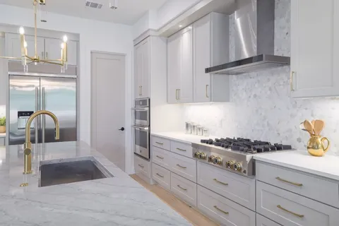 a kitchen with granite countertop a stove and cabinets