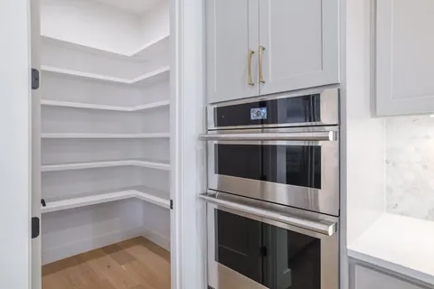 a kitchen with stainless steel appliances and cabinets