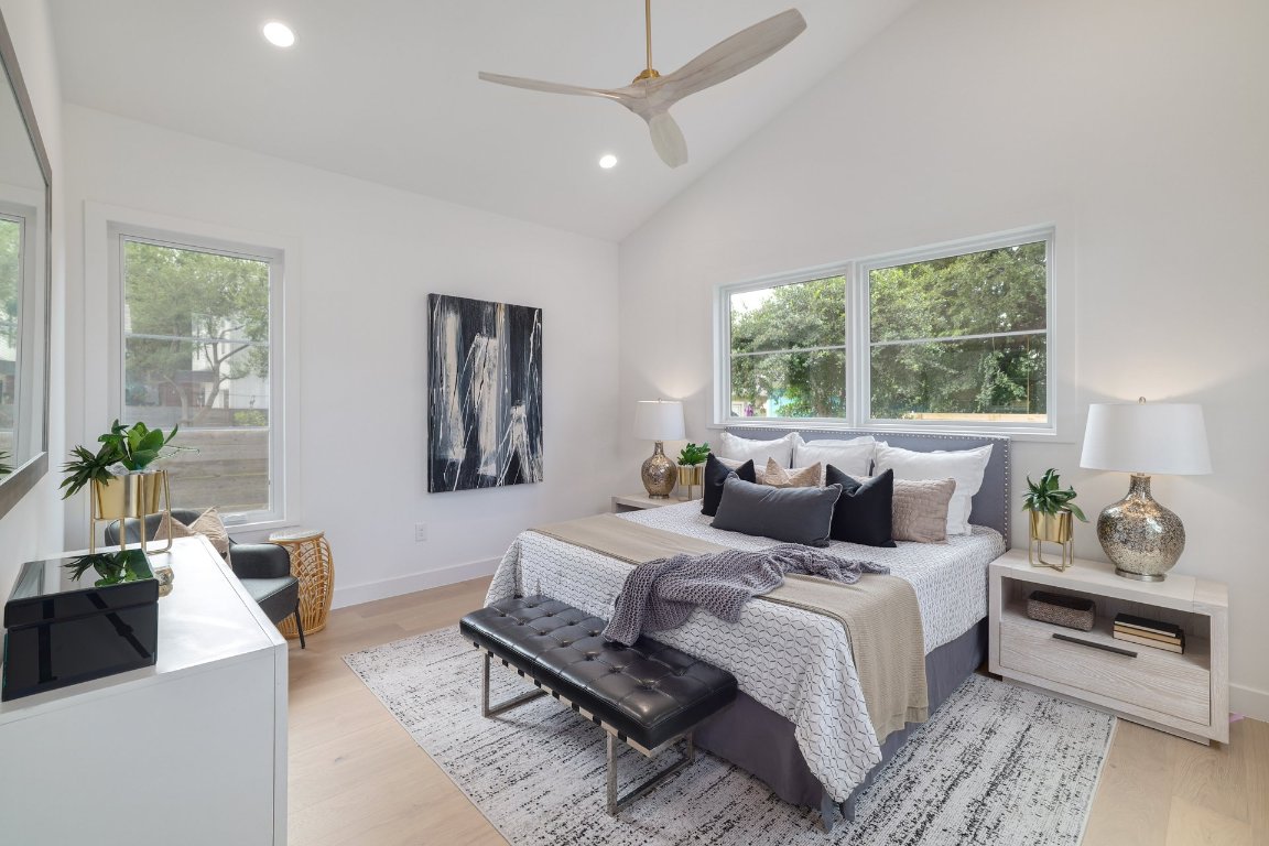 1703 Piedmont Avenue Austin, TX 78757 - Photo 18 of 37 a bedroom with a large bed and a couch