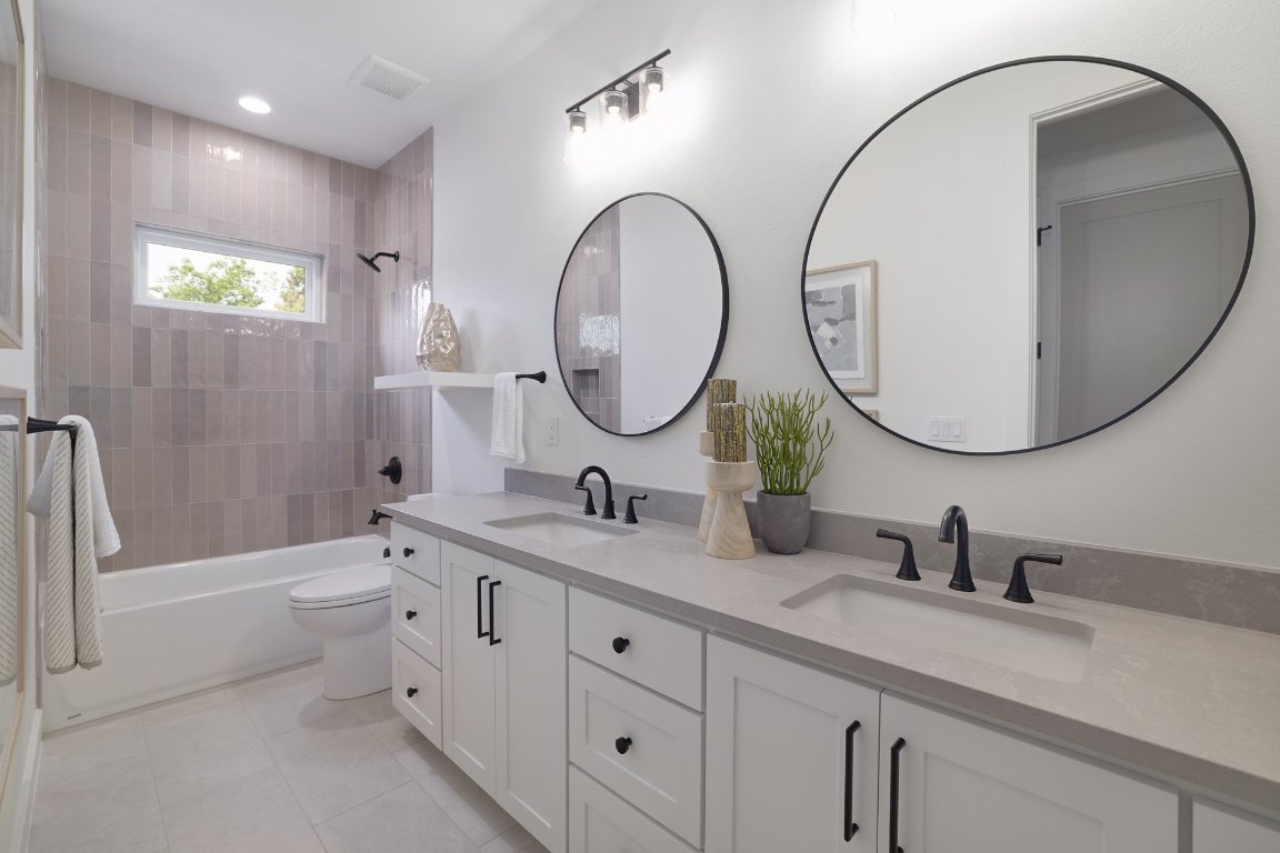 1703 Piedmont Avenue Austin, TX 78757 - Photo 30 of 37 a bathroom with a double vanity sink and a mirror