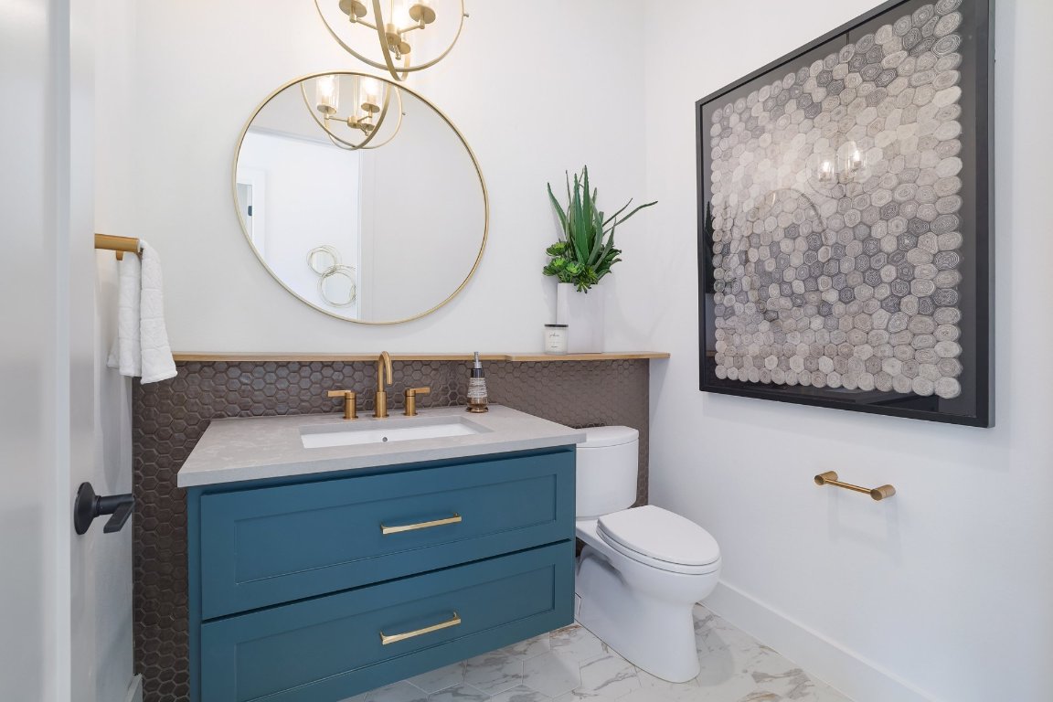 1703 Piedmont Avenue Austin, TX 78757 - Photo 32 of 37 a bathroom with a toilet a sink and mirror