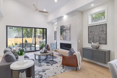 a living room with furniture and a floor to ceiling window
