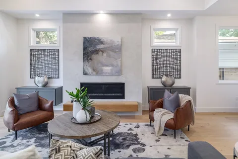 a living room with furniture potted plant and window