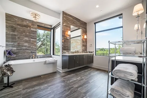 a living room with a couch wooden floor and a large window