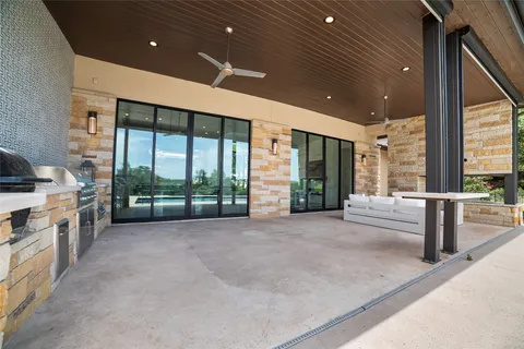 a large room with a large window and stainless steel appliances