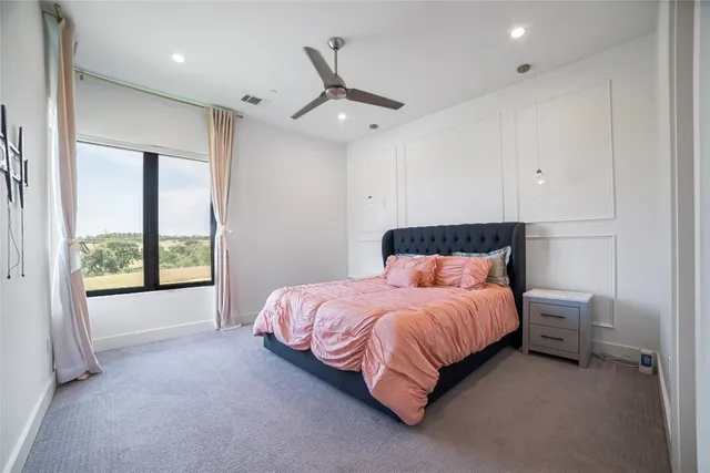 a bedroom with a bed and a large window