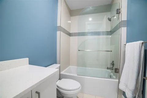 a bathroom with a sink a toilet a bathtub and shower