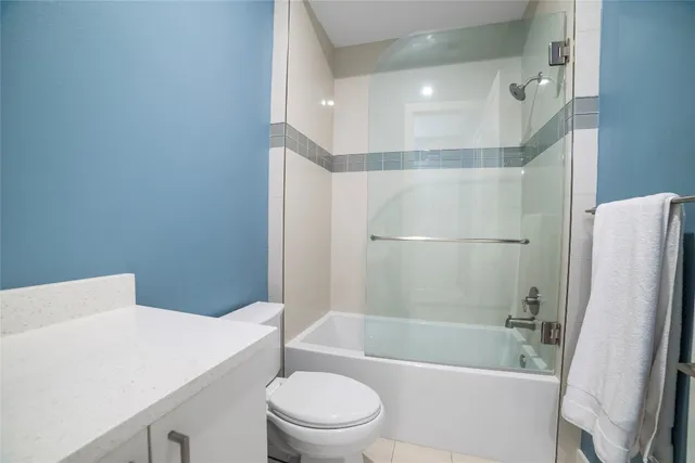 a bathroom with a sink a toilet a bathtub and shower