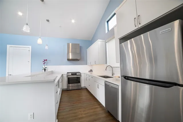 a kitchen with cabinets a sink and appliances
