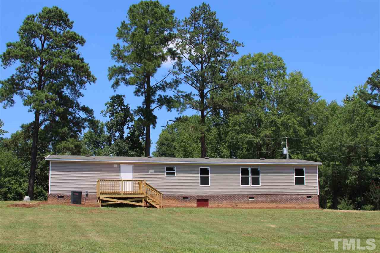 10395 Smith Road Middlesex, NC 27557 - Photo 4 of 12 View of the back of the beautiful manufactured home from the back yard. Look at all that space!