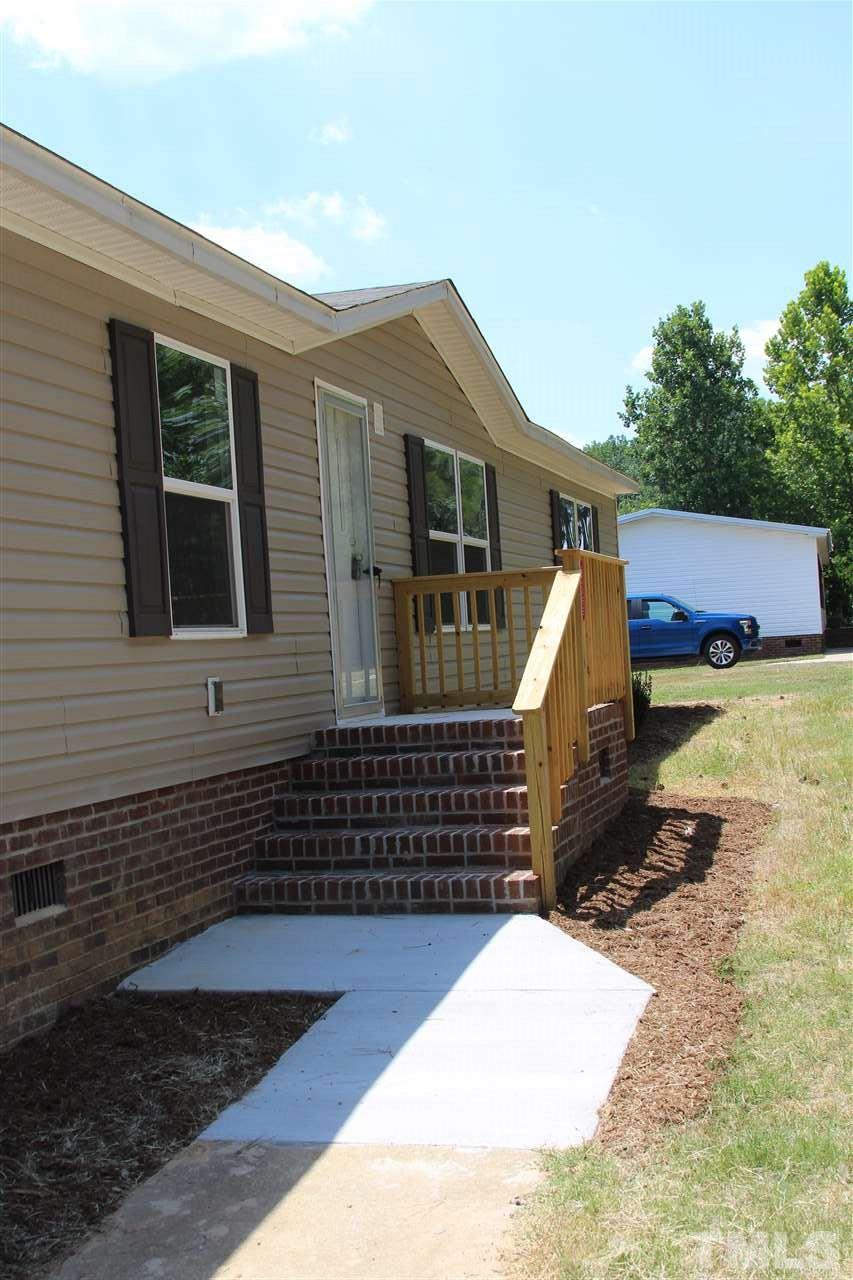 10395 Smith Road Middlesex, NC 27557 - Photo 8 of 12 Paved walkway from driveway to front door, and nice brick stoop welcome you home.
