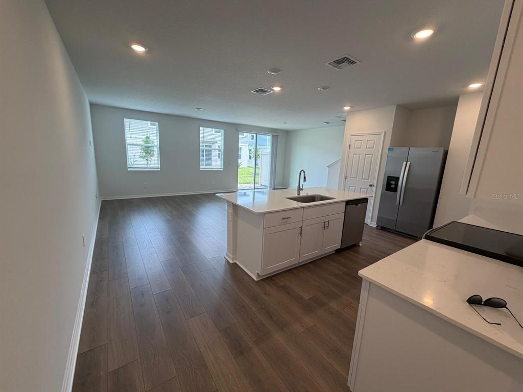 4244 Ranch House Road St. Cloud, FL 34772 - Photo 4 of 34 a view of an empty room with wooden floor and a window