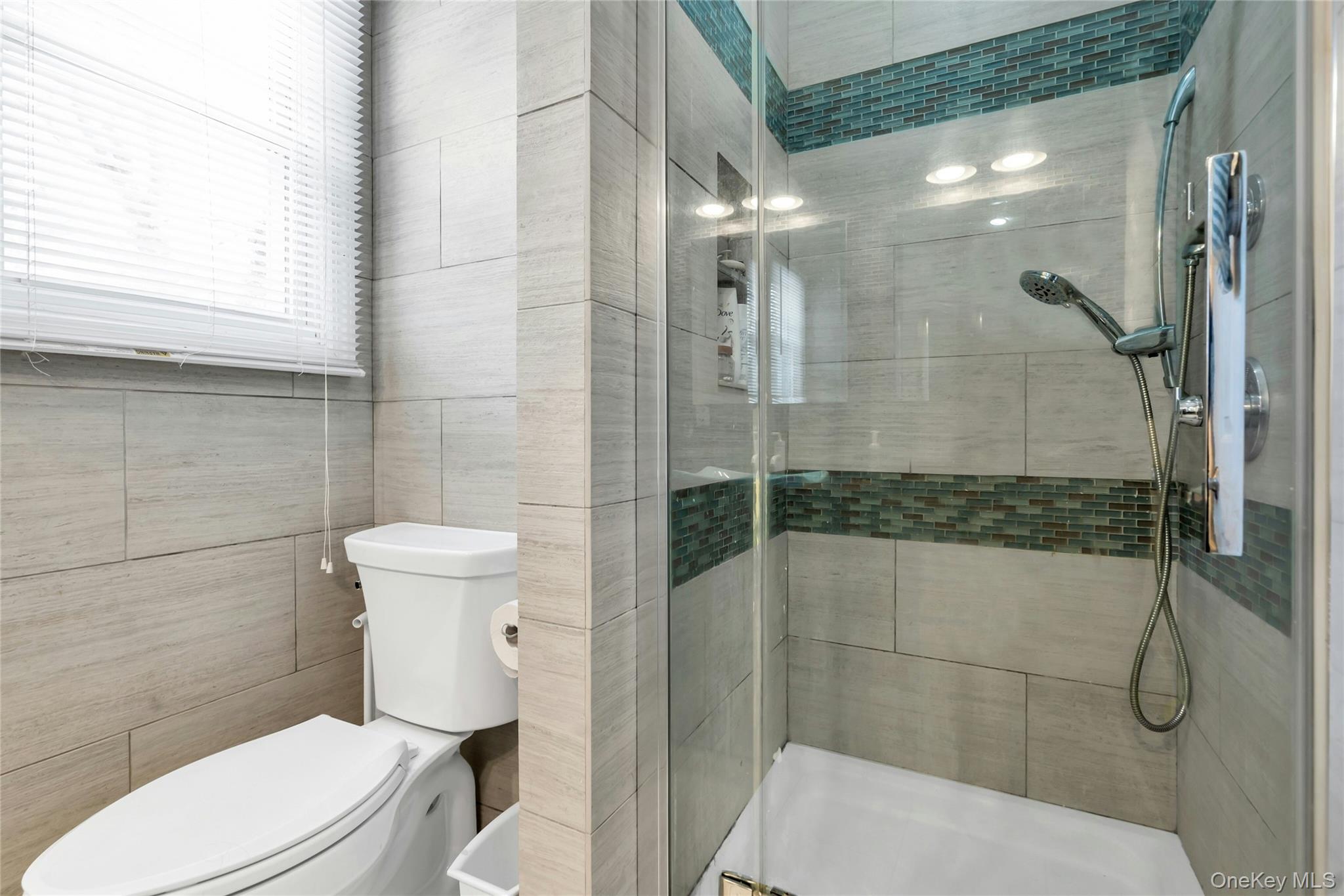 54 Valleywood Road Commack, NY 11725 - Photo 18 of 33 a white toilet sitting next to a bathroom sink