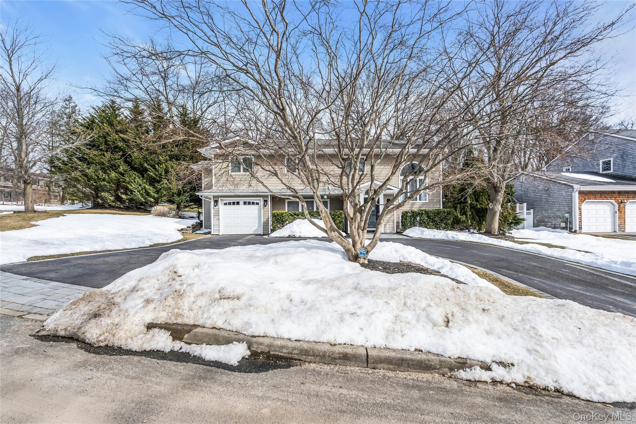 54 Valleywood Road Commack, NY 11725 - Photo 2 of 33 a white house that has a tree on the side of it