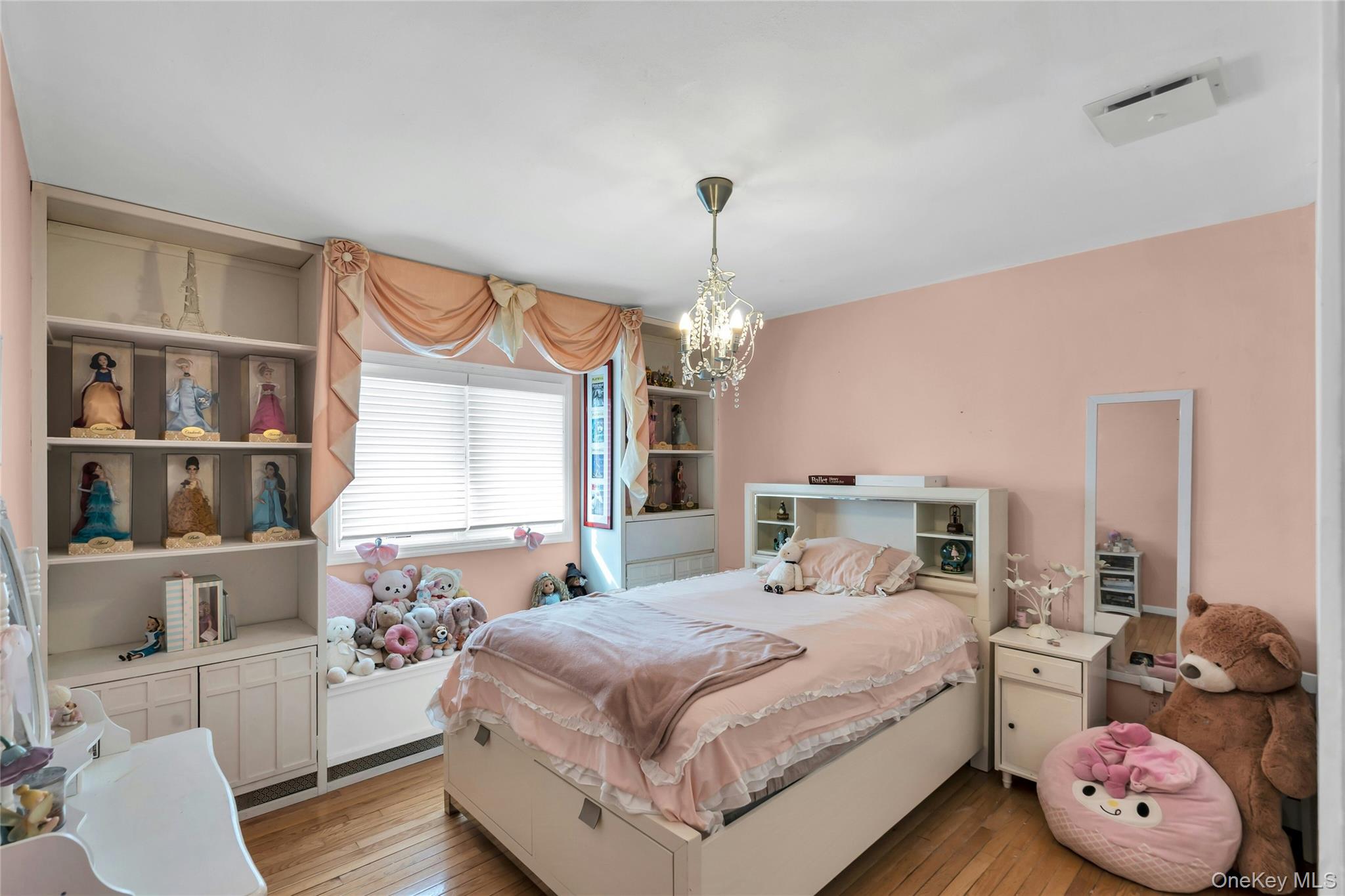 54 Valleywood Road Commack, NY 11725 - Photo 21 of 33 a bedroom with a bed window and book shelf