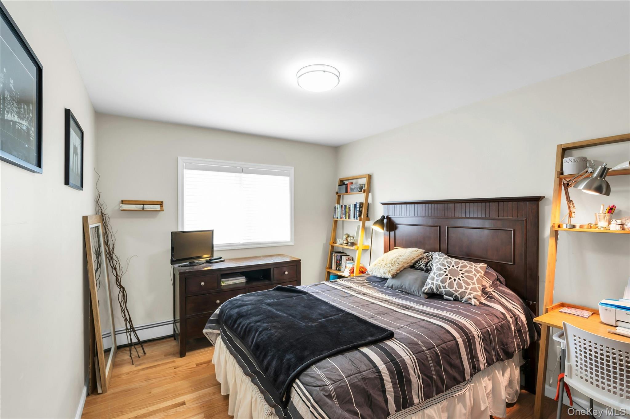 54 Valleywood Road Commack, NY 11725 - Photo 23 of 33 a bedroom with a bed and a desk