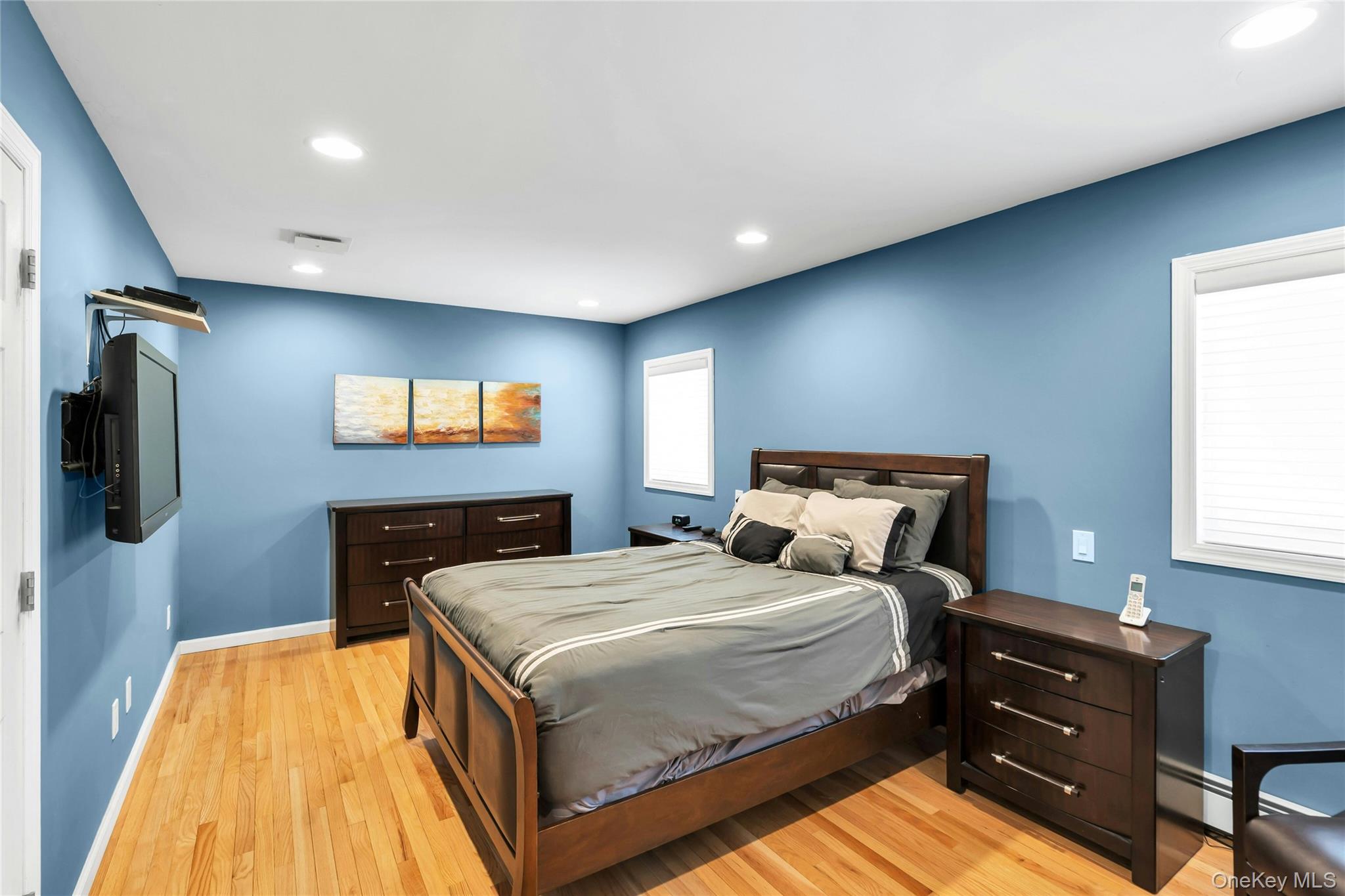 54 Valleywood Road Commack, NY 11725 - Photo 25 of 33 a bedroom with a bed and a flat screen tv