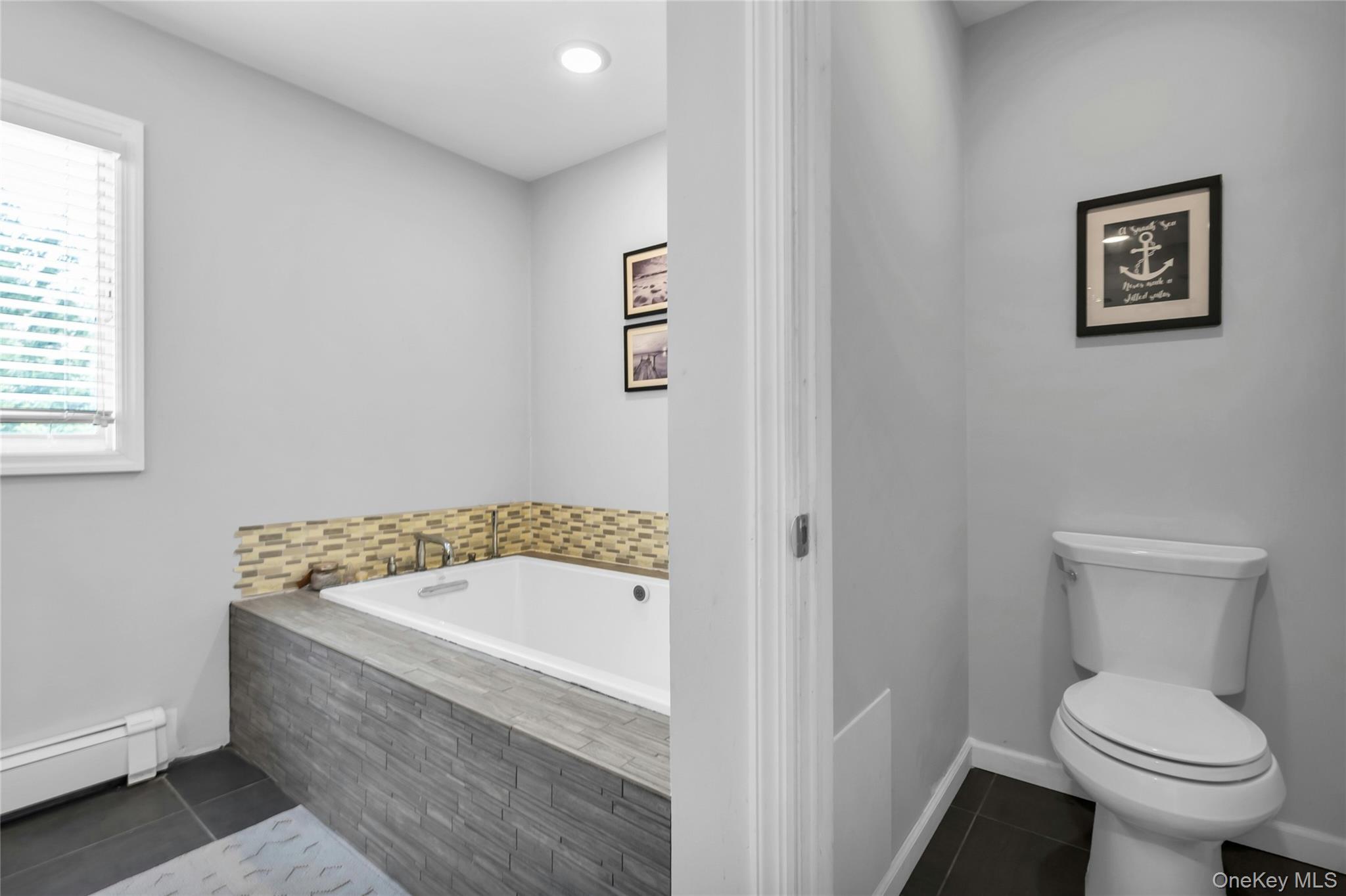 54 Valleywood Road Commack, NY 11725 - Photo 29 of 33 a bathroom with a sink and a toilet