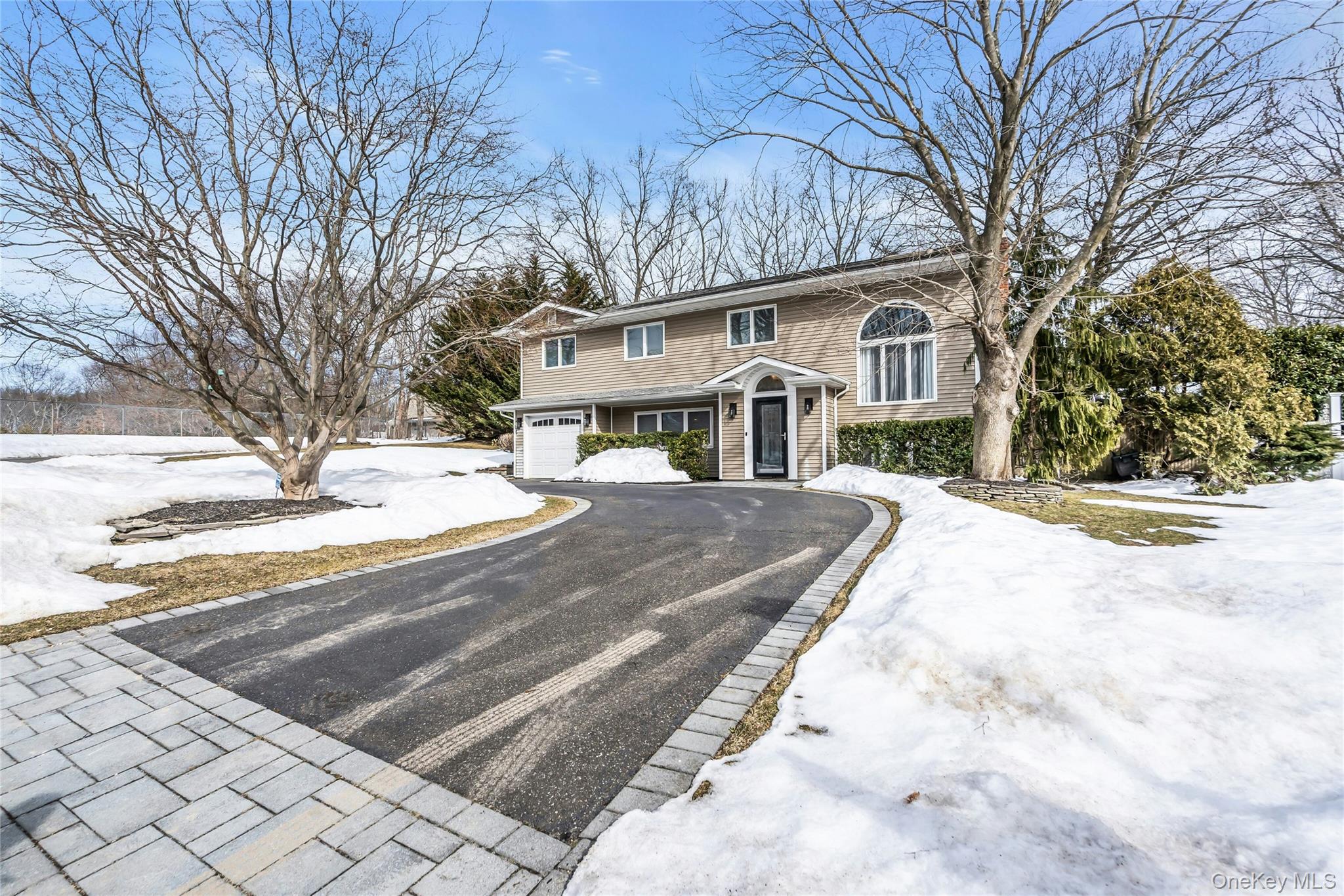 54 Valleywood Road Commack, NY 11725 - Photo 3 of 33 a view of a white house with a snow on the road