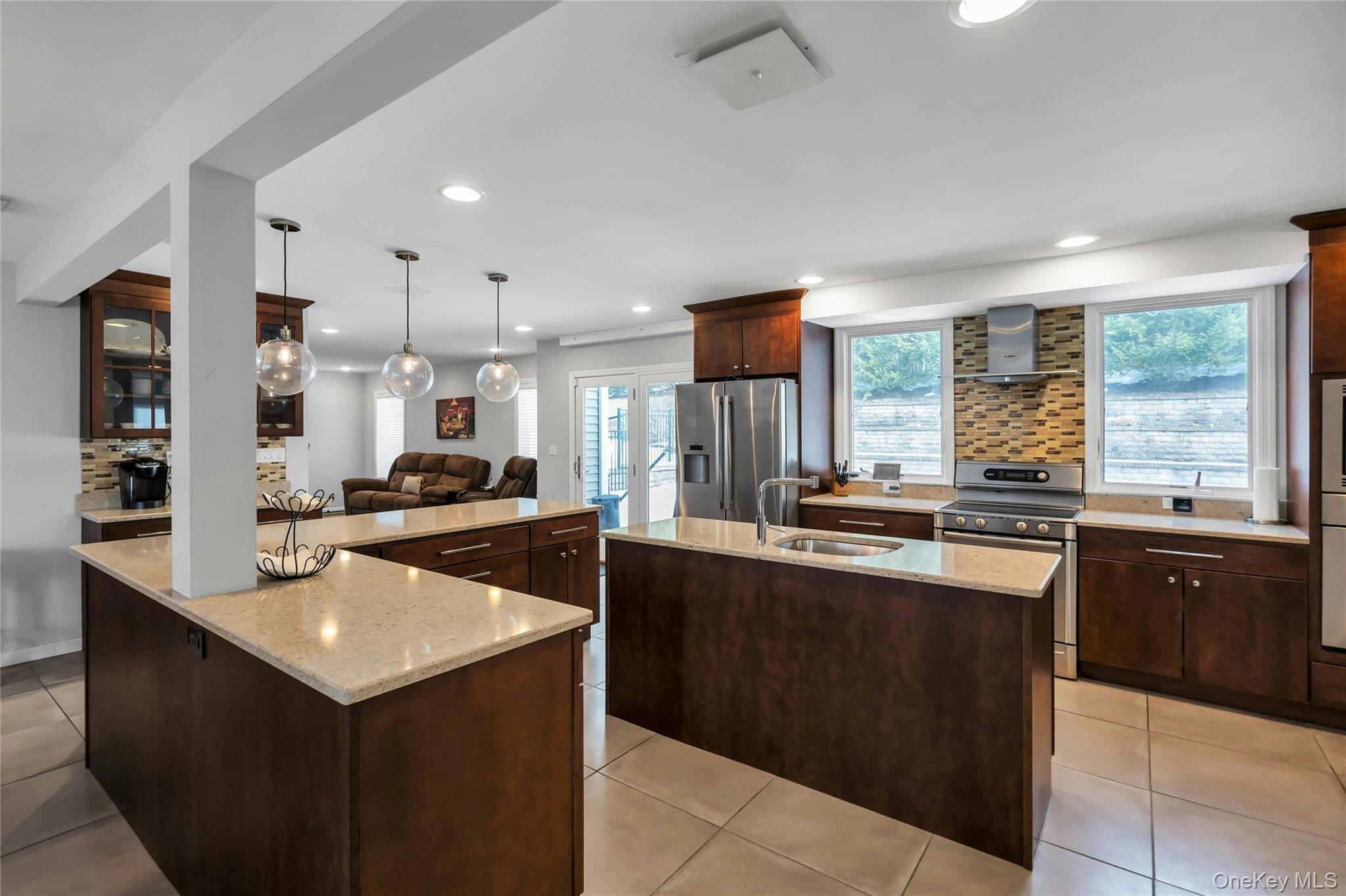 54 Valleywood Road Commack, NY 11725 - Photo 5 of 33 a kitchen with stainless steel appliances granite countertop a sink counter space cabinets and a large window
