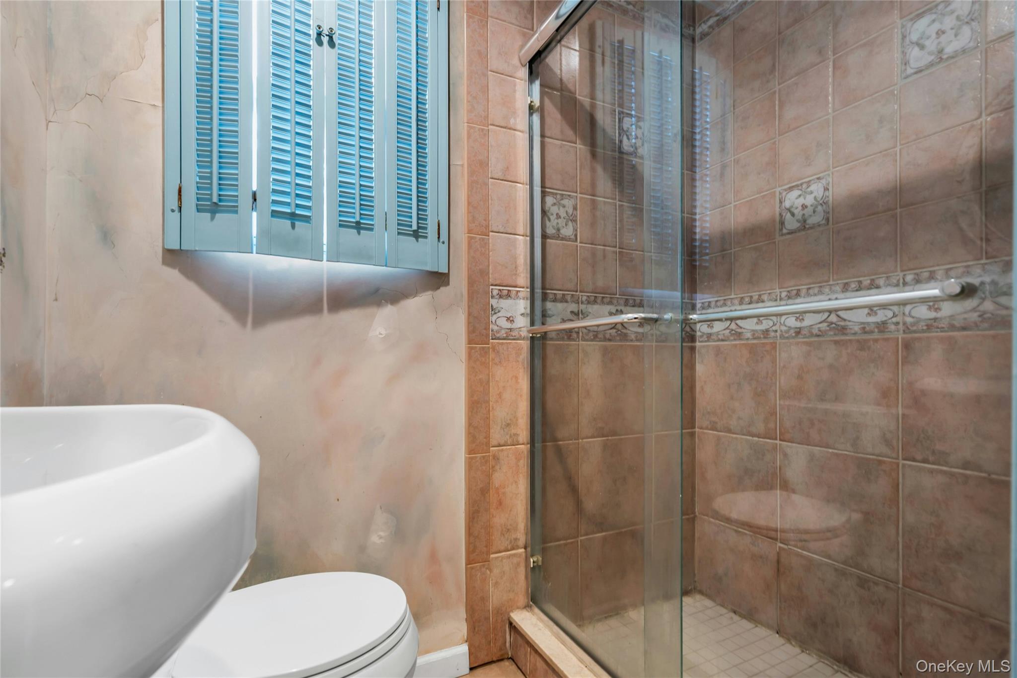 54 Valleywood Road Commack, NY 11725 - Photo 10 of 33 a bathroom with a toilet and shower