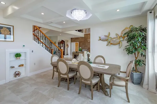 a dining room with furniture entryway and wooden floor