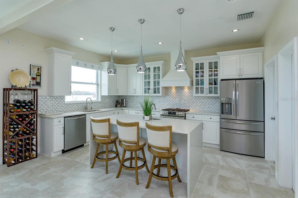 1201 South Riverside Drive Edgewater, FL 32132 - Photo 14 of 47 a kitchen with refrigerator and cabinets