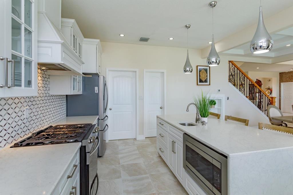 1201 South Riverside Drive Edgewater, FL 32132 - Photo 17 of 47 a kitchen with stainless steel appliances granite countertop a sink and a stove