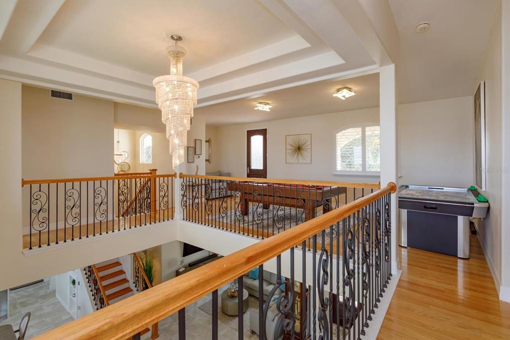 1201 South Riverside Drive Edgewater, FL 32132 - Photo 22 of 47 a view of a hallway with wooden floor and staircase