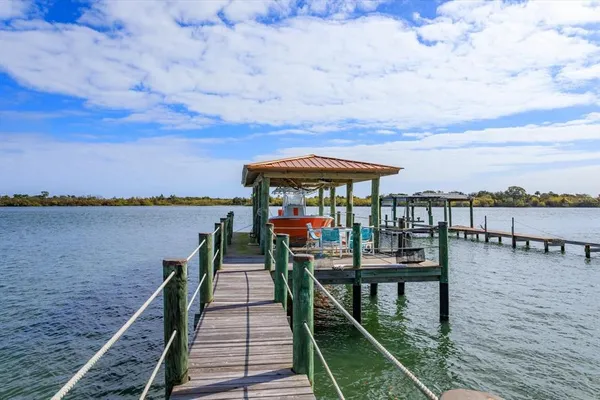 a view of a balcony with chairs and wooden floor