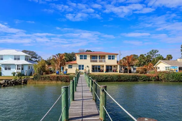 a view of residential houses with outdoor space and lake view